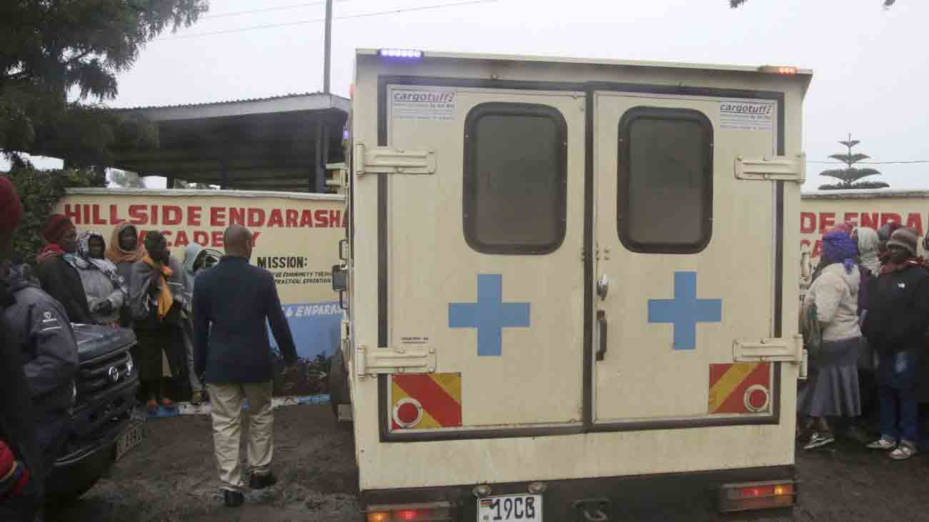 An ambulance stands outside a fire-ravaged school in Kenya's capital, Nairobi.